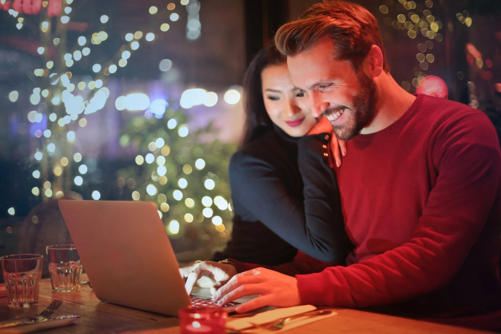 man and woman using laptop