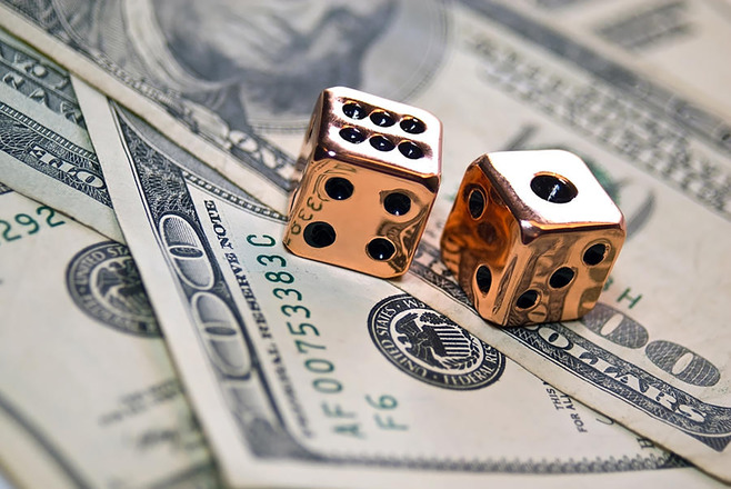 Image of golden dice and dollar bills