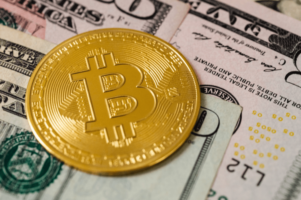 A Bitcoin on U.S. dollar banknotes