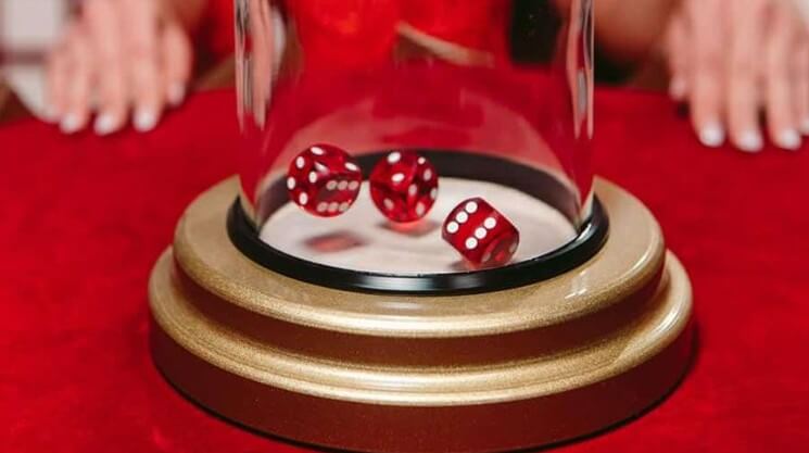 Dice shaken under a glass dome