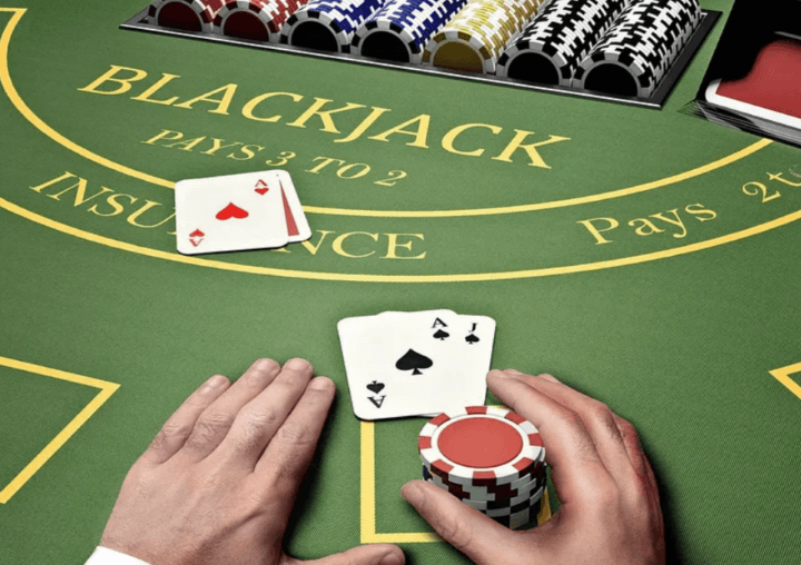 A gambler in a land-based casino making bets on Blackjack with chips