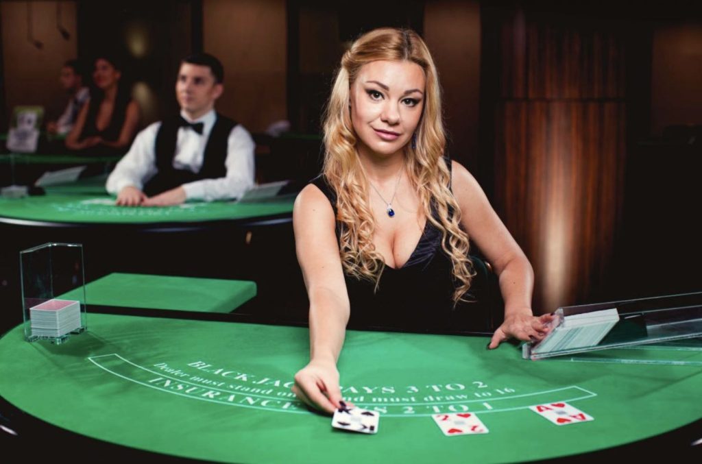 A professional live dealer in a casino that places cards on the table 