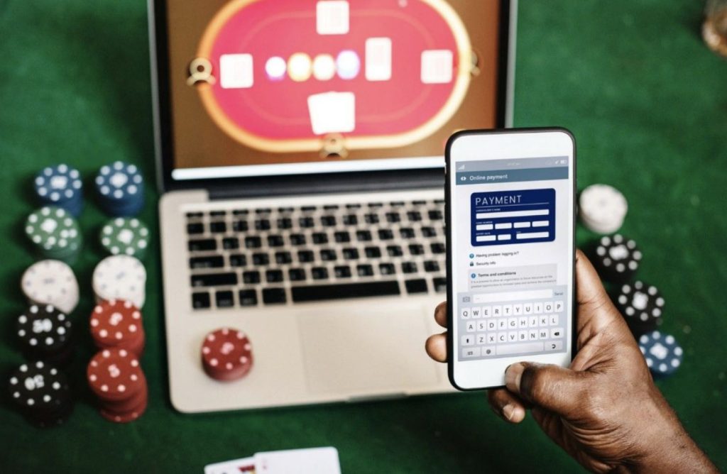 A person using their phone to make a payment and play card games
