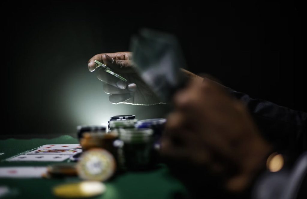 A person placing chips on a Poker table